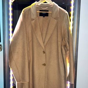 A classic light camel colored mid-weight, duster coat.